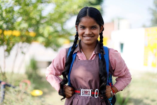 Cheerful Indian schoolgirl in uniform smiling outdoors in Lucknow, India.